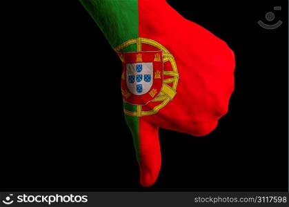 Hand with thumbs down gesture in colored portugal national flag as symbol of negative political, cultural, social management of country