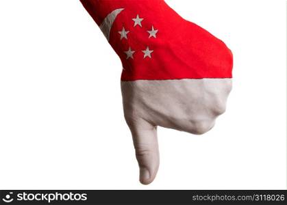 Hand with thumbs down gesture in colored singapore national flag as symbol of negative political, cultural, social management of country
