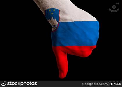 Hand with thumbs down gesture in colored slovenia national flag as symbol of negative political, cultural, social management of country
