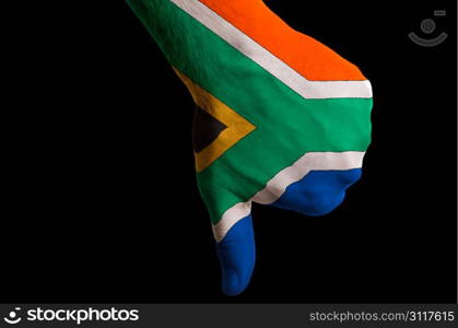 Hand with thumbs down gesture in colored south africa national flag as symbol of negative political, cultural, social management of country