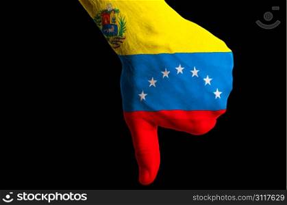 Hand with thumbs down gesture in colored venezuelan national flag as symbol of negative political, cultural, social management of country