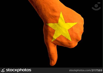 Hand with thumbs down gesture in colored vietnam national flag as symbol of negative political, cultural, social management of country