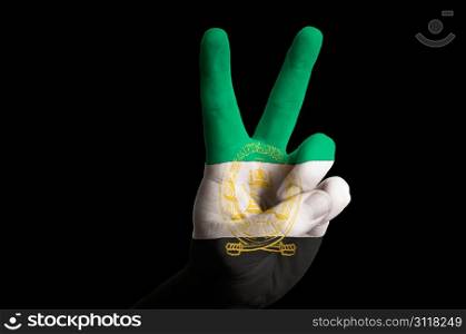 Hand with two finger up gesture in colored afghanistan national flag as symbol of winning, victorious, excellent, - for tourism and touristic advertising, positive political, cultural, social management of country