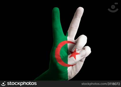 Hand with two finger up gesture in colored algeria national flag as symbol of winning, victorious, excellent, - for tourism and touristic advertising, positive political, cultural, social management of country