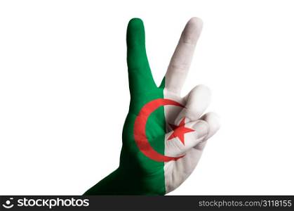 Hand with two finger up gesture in colored algeria national flag as symbol of winning, victorious, excellent, - for tourism and touristic advertising, positive political, cultural, social management of country