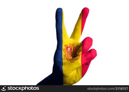 Hand with two finger up gesture in colored andorra national flag as symbol of winning, victorious, excellent, - for tourism and touristic advertising, positive political, cultural, social management of country