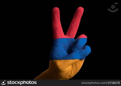 Hand with two finger up gesture in colored armenia national flag as symbol of winning, victorious, excellent, - for tourism and touristic advertising, positive political, cultural, social management of country