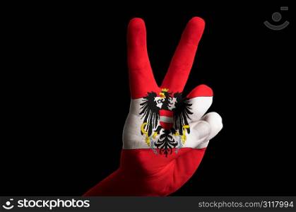 Hand with two finger up gesture in colored austria national flag as symbol of winning, victorious, excellent, - for tourism and touristic advertising, positive political, cultural, social management of country