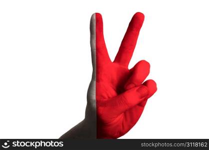 Hand with two finger up gesture in colored bahrain national flag as symbol of winning, victorious, excellent, - for tourism and touristic advertising, positive political, cultural, social management of country