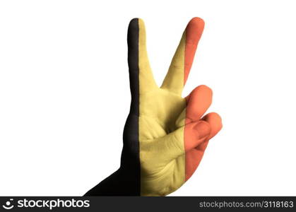 Hand with two finger up gesture in colored belgium national flag as symbol of winning, victorious, excellent, - for tourism and touristic advertising, positive political, cultural, social management of country