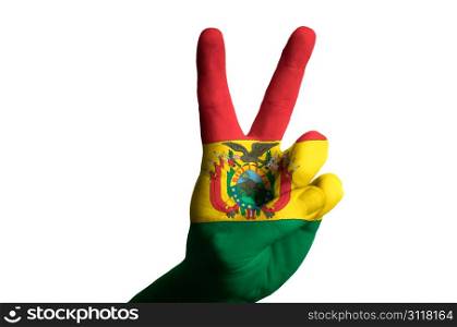 Hand with two finger up gesture in colored bolivia national flag as symbol of winning, victorious, excellent, - for tourism and touristic advertising, positive political, cultural, social management of country