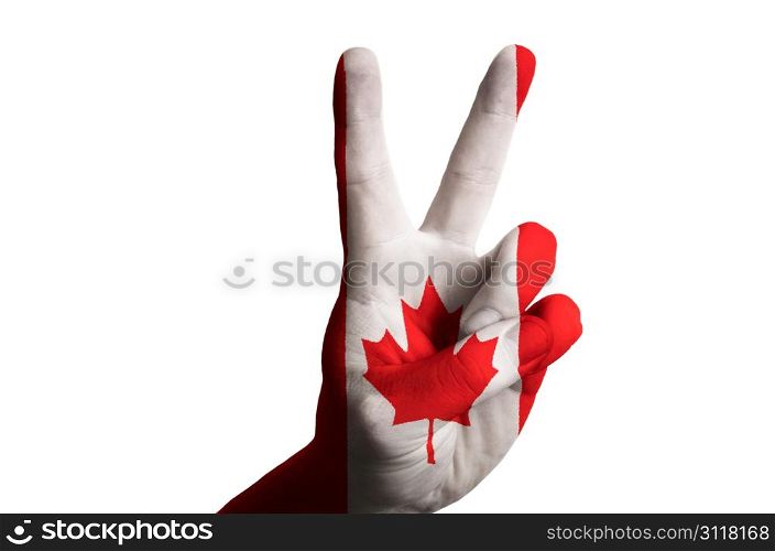 Hand with two finger up gesture in colored canada national flag as symbol of winning, victorious, excellent, - for tourism and touristic advertising, positive political, cultural, social management of country