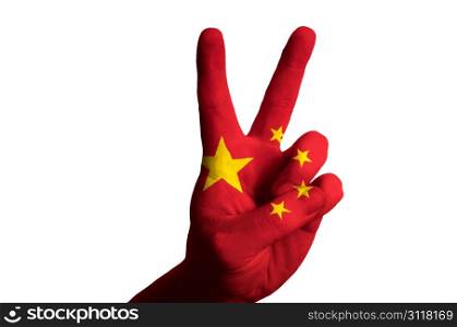Hand with two finger up gesture in colored china national flag as symbol of winning, victorious, excellent, - for tourism and touristic advertising, positive political, cultural, social management of country