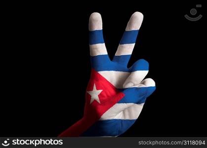 Hand with two finger up gesture in colored cuba national flag as symbol of winning, victorious, excellent, - for tourism and touristic advertising, positive political, cultural, social management of country