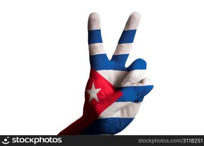 Hand with two finger up gesture in colored cuba national flag as symbol of winning, victorious, excellent, - for tourism and touristic advertising, positive political, cultural, social management of country