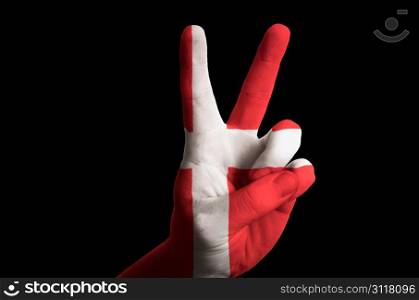 Hand with two finger up gesture in colored denmark national flag as symbol of winning, victorious, excellent, - for tourism and touristic advertising, positive political, cultural, social management of country