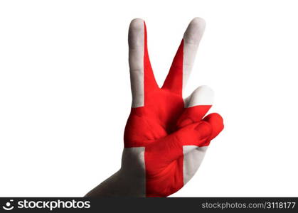 Hand with two finger up gesture in colored england national flag as symbol of winning, victorious, excellent, - for tourism and touristic advertising, positive political, cultural, social management of country