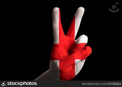 Hand with two finger up gesture in colored england national flag as symbol of winning, victorious, excellent, - for tourism and touristic advertising, positive political, cultural, social management of country