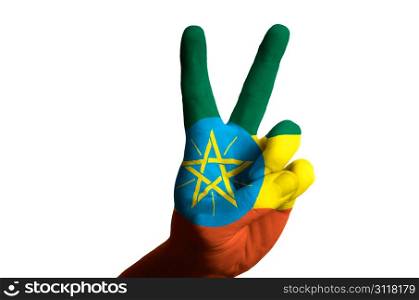 Hand with two finger up gesture in colored ethiopia national flag as symbol of winning, victorious, excellent, - for tourism and touristic advertising, positive political, cultural, social management of country