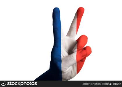 Hand with two finger up gesture in colored france national flag as symbol of winning, victorious, excellent, - for tourism and touristic advertising, positive political, cultural, social management of country
