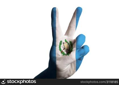 Hand with two finger up gesture in colored guatemala national flag as symbol of winning, victorious, excellent, - for tourism and touristic advertising, positive political, cultural, social management of country