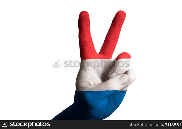 Hand with two finger up gesture in colored holland national flag as symbol of winning, victorious, excellent, - for tourism and touristic advertising, positive political, cultural, social management of country