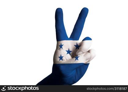 Hand with two finger up gesture in colored honduras national flag as symbol of winning, victorious, excellent, - for tourism and touristic advertising, positive political, cultural, social management of country