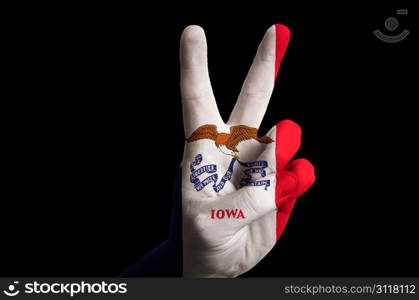 Hand with two finger up gesture in colored iowa state flag as symbol of winning, victorious, excellent, - for tourism and touristic advertising, positive political, cultural, social management of country