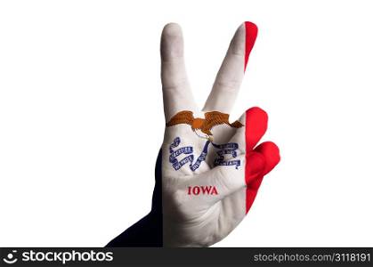 Hand with two finger up gesture in colored iowa state flag as symbol of winning, victorious, excellent, - for tourism and touristic advertising, positive political, cultural, social management of country
