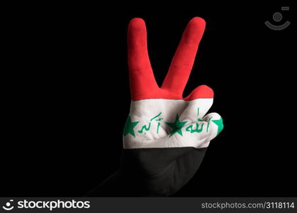 Hand with two finger up gesture in colored iraq national flag as symbol of winning, victorious, excellent, - for tourism and touristic advertising, positive political, cultural, social management of country