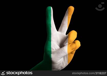 Hand with two finger up gesture in colored ireland national flag as symbol of winning, victorious, excellent, - for tourism and touristic advertising, positive political, cultural, social management of country