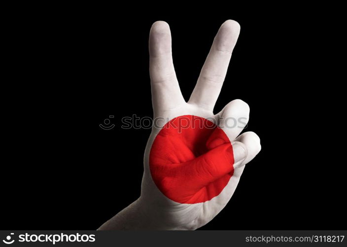 Hand with two finger up gesture in colored japan national flag as symbol of winning, victorious, excellent, - for tourism and touristic advertising, positive political, cultural, social management of country