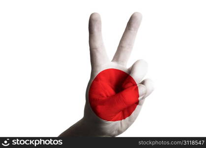 Hand with two finger up gesture in colored japan national flag as symbol of winning, victorious, excellent, - for tourism and touristic advertising, positive political, cultural, social management of country