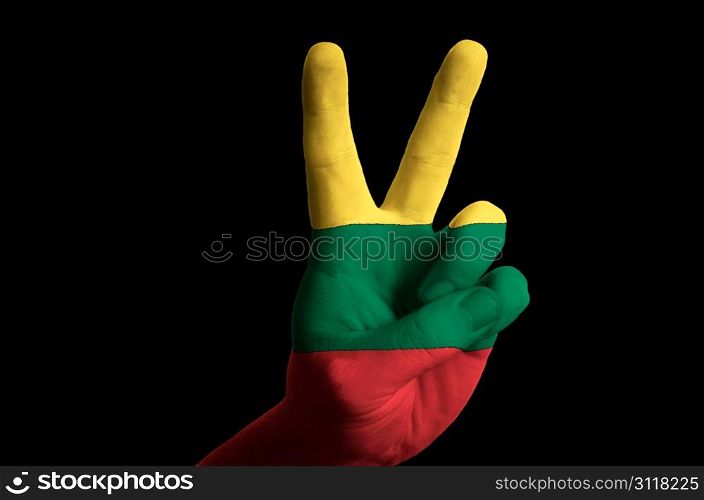 Hand with two finger up gesture in colored lithuania national flag as symbol of winning, victorious, excellent, - for tourism and touristic advertising, positive political, cultural, social management of country