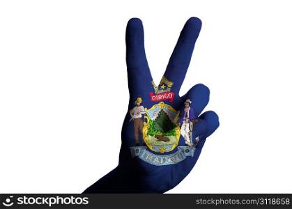 Hand with two finger up gesture in colored maine state flag as symbol of winning, victorious, excellent, - for tourism and touristic advertising, positive political, cultural, social management of country