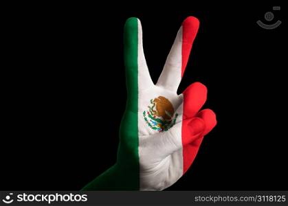 Hand with two finger up gesture in colored mexico national flag as symbol of winning, victorious, excellent, - for tourism and touristic advertising, positive political, cultural, social management of country