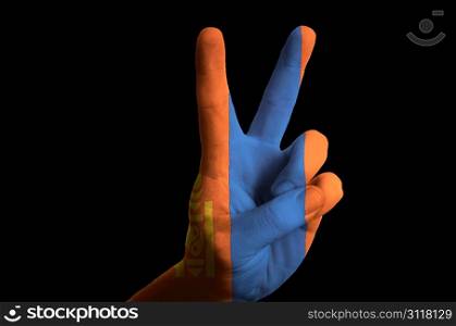 Hand with two finger up gesture in colored mongolia national flag as symbol of winning, victorious, excellent, - for tourism and touristic advertising, positive political, cultural, social management of country