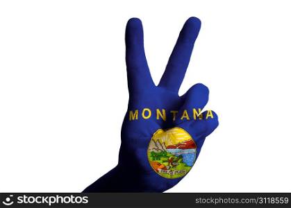 Hand with two finger up gesture in colored montana state flag as symbol of winning, victorious, excellent, - for tourism and touristic advertising, positive political, cultural, social management of country