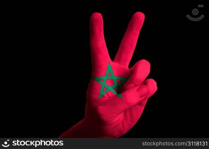 Hand with two finger up gesture in colored morocco national flag as symbol of winning, victorious, excellent, - for tourism and touristic advertising, positive political, cultural, social management of country