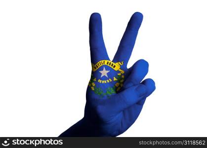 Hand with two finger up gesture in colored nevada state flag as symbol of winning, victorious, excellent, - for tourism and touristic advertising, positive political, cultural, social management of country