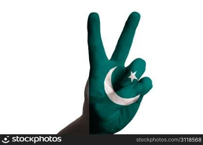 Hand with two finger up gesture in colored pakistan national flag as symbol of winning, victorious, excellent, - for tourism and touristic advertising, positive political, cultural, social management of country