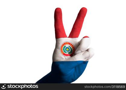 Hand with two finger up gesture in colored paraguay national flag as symbol of winning, victorious, excellent, - for tourism and touristic advertising, positive political, cultural, social management of country
