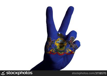 Hand with two finger up gesture in colored pennsylvania american state flag as symbol of winning, victorious, excellent, - for tourism and touristic advertising, positive political, cultural, social management of country