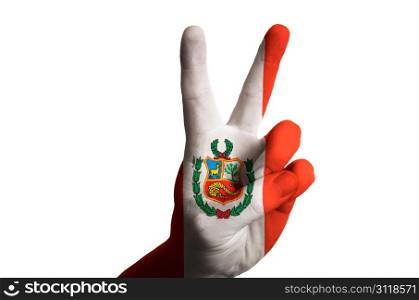 Hand with two finger up gesture in colored peru national flag as symbol of winning, victorious, excellent, - for tourism and touristic advertising, positive political, cultural, social management of country