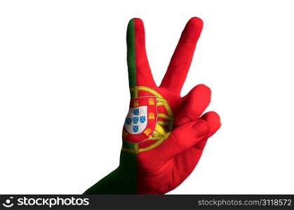Hand with two finger up gesture in colored portugal national flag as symbol of winning, victorious, excellent, - for tourism and touristic advertising, positive political, cultural, social management of country