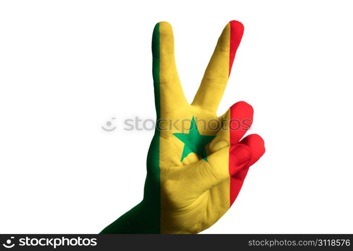 Hand with two finger up gesture in colored senegal national flag as symbol of winning, victorious, excellent, - for tourism and touristic advertising, positive political, cultural, social management of country