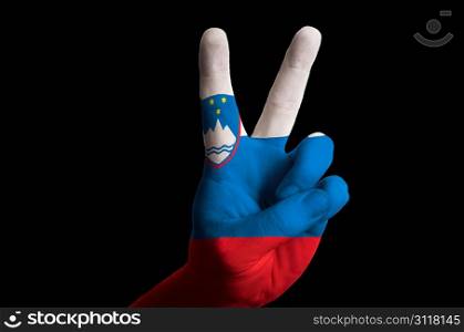 Hand with two finger up gesture in colored slovenia national flag as symbol of winning, victorious, excellent, - for tourism and touristic advertising, positive political, cultural, social management of country