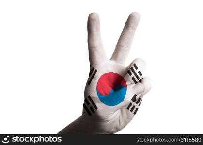 Hand with two finger up gesture in colored south korea national flag as symbol of winning, victorious, excellent, - for tourism and touristic advertising, positive political, cultural, social management of country