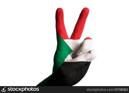 Hand with two finger up gesture in colored sudan national flag as symbol of winning, victorious, excellent, - for tourism and touristic advertising, positive political, cultural, social management of country