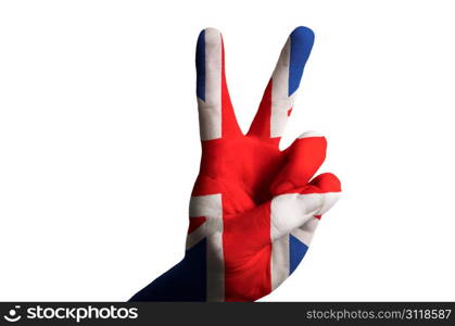 Hand with two finger up gesture in colored uk national flag as symbol of winning, victorious, excellent, - for tourism and touristic advertising, positive political, cultural, social management of country